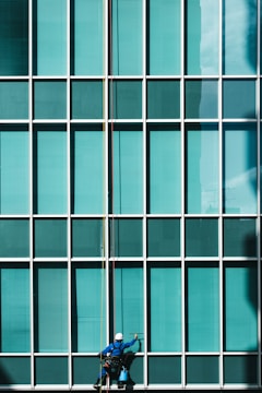 man cleaning glass mirrors
