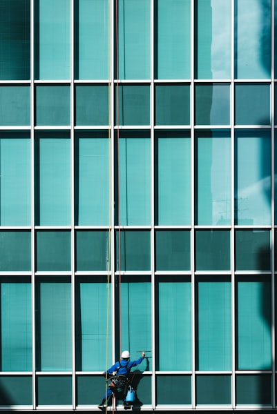 Close-up of professional cleaner working on glass