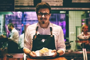 man holding fish dish on plate