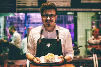 man holding fish dish on plate