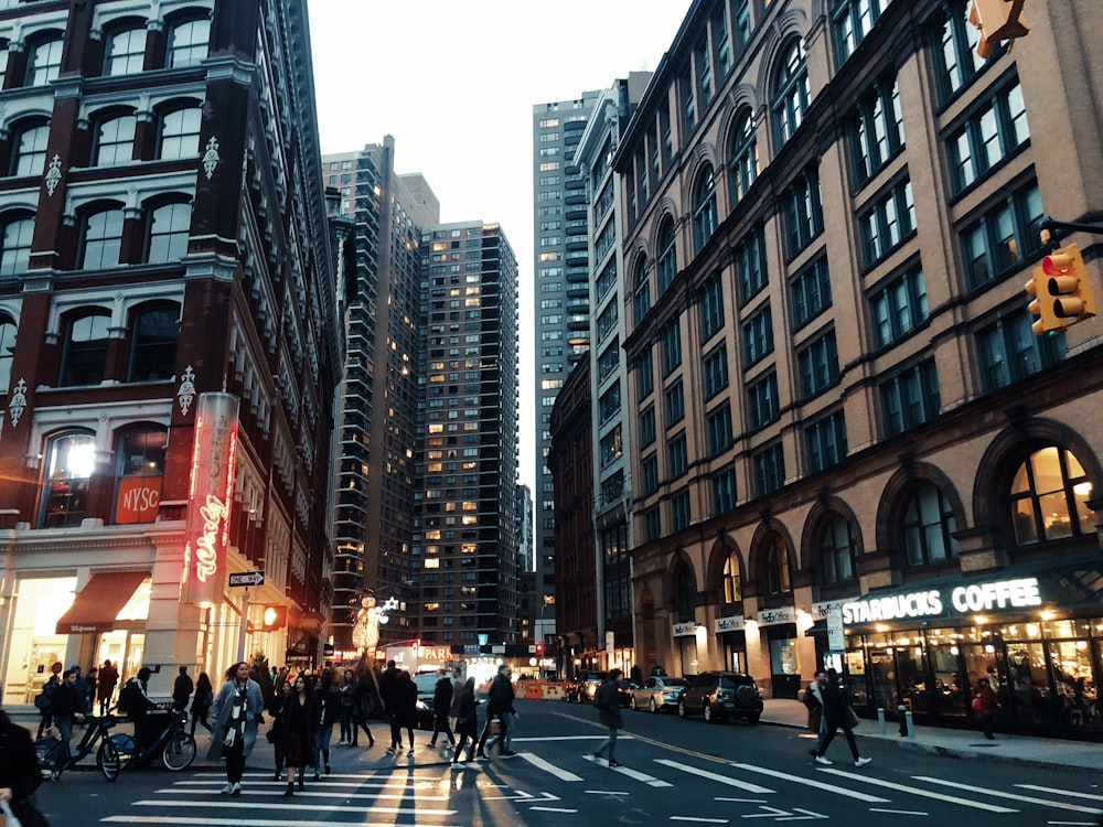 people walking near street surrounded by buildings during daytime