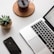 space gray iPhone X beside turned on laptop beside coffee and succulent plant