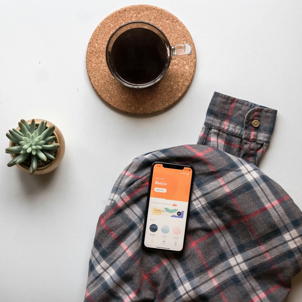 black smartphone on long-sleeved shirt