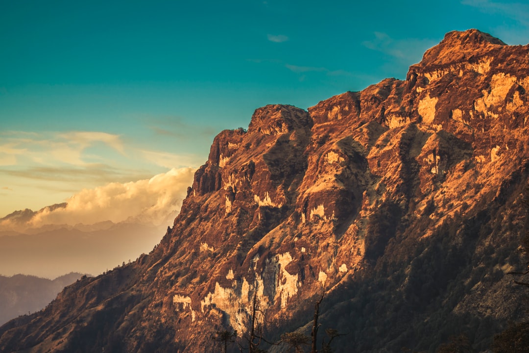 bird's-eye view of mountain across white clouds