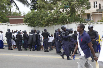 A team of uniformed security personnel standing with walkie-talkies ready during an event.