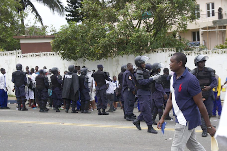 A team of uniformed security personnel standing with walkie-talkies ready during an event.