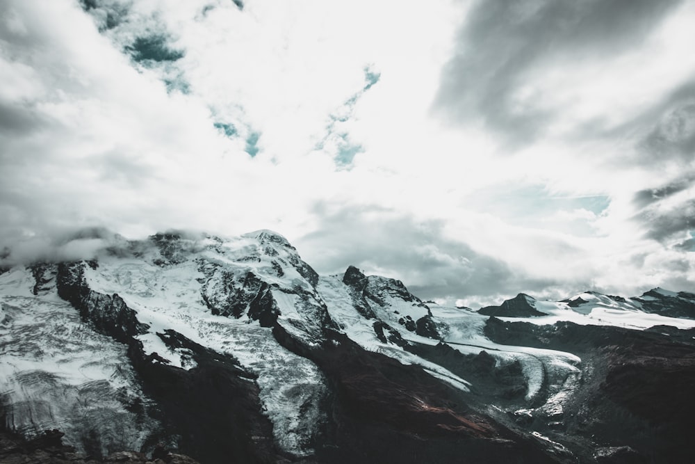 mountain coated snow under white sky