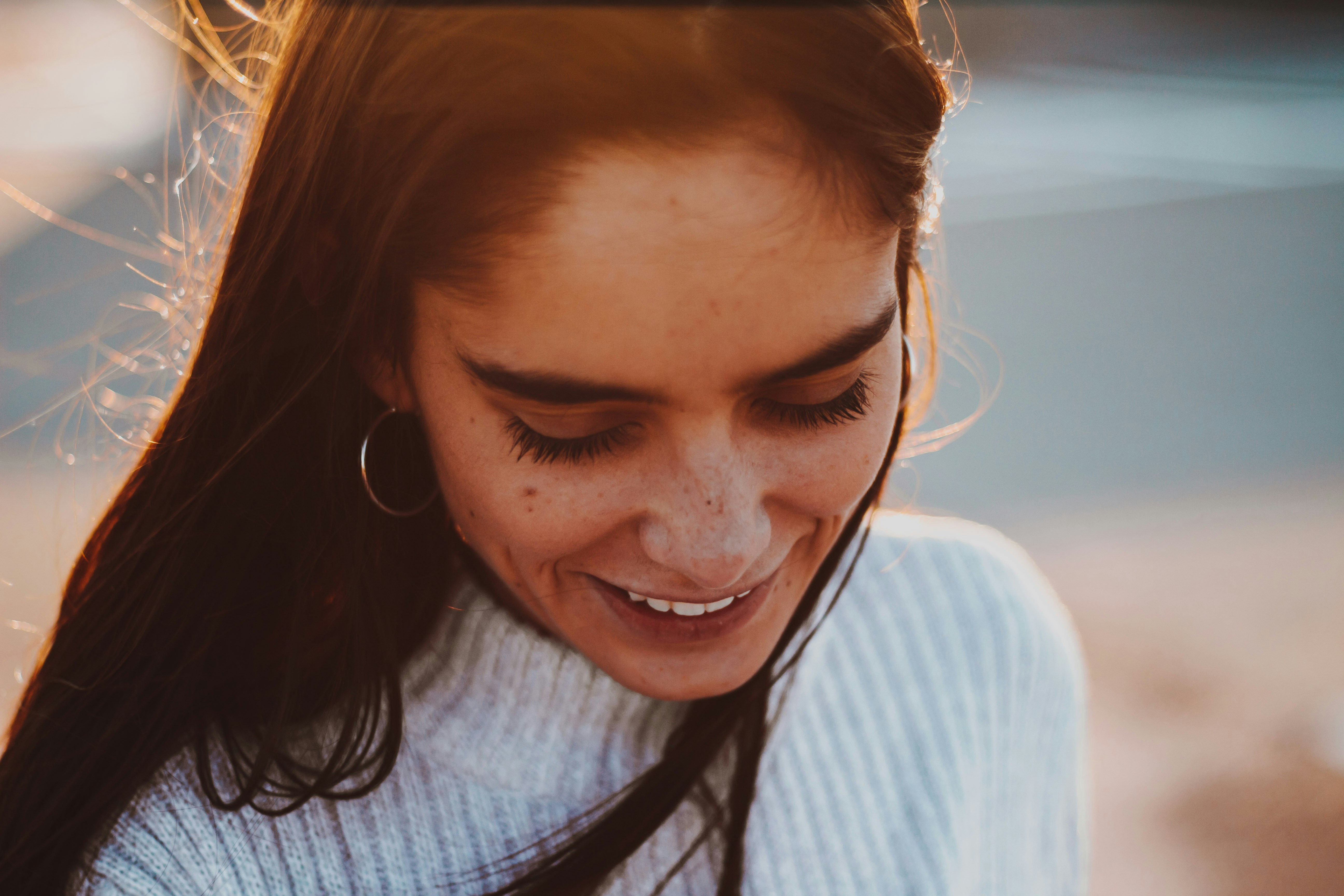 Woman in white turtleneck smiling