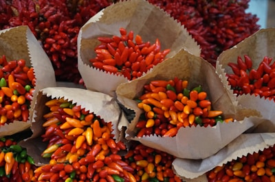 Colorful packages of traditional Mexican chili peppers displayed in a market setting.