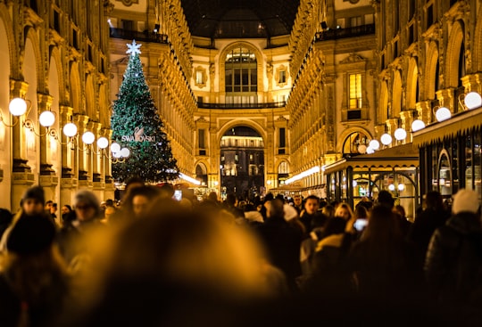 man and woman passing on cathedral in Galleria Vittorio Emanuele II Italy