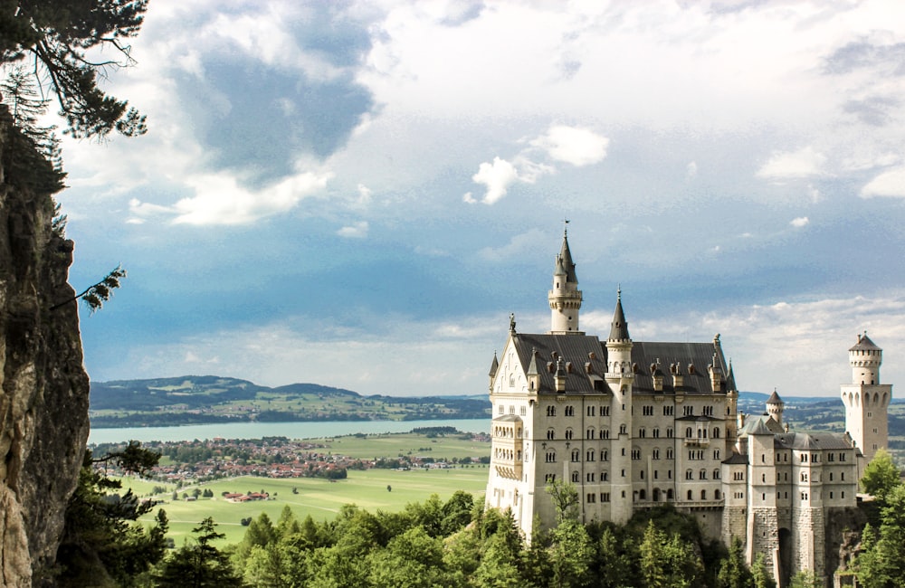 a castle on top of a hill with a view of a lake