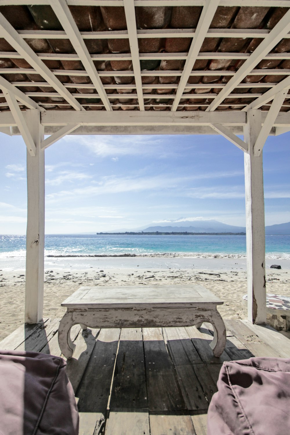 rectangular white wooden coffee table near body of water