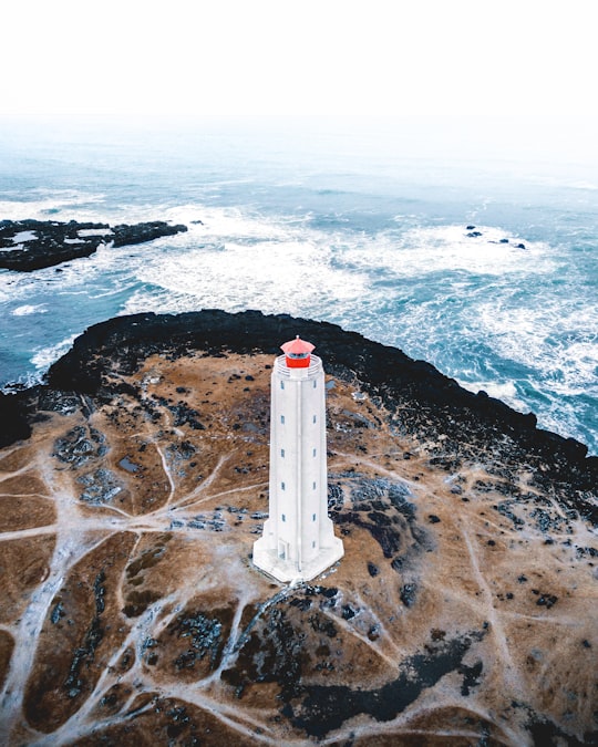 bird's eye photography of white lighthouse tower near ocean in Snaefellsnes Iceland