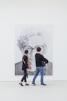 man and woman looking at woman's painting