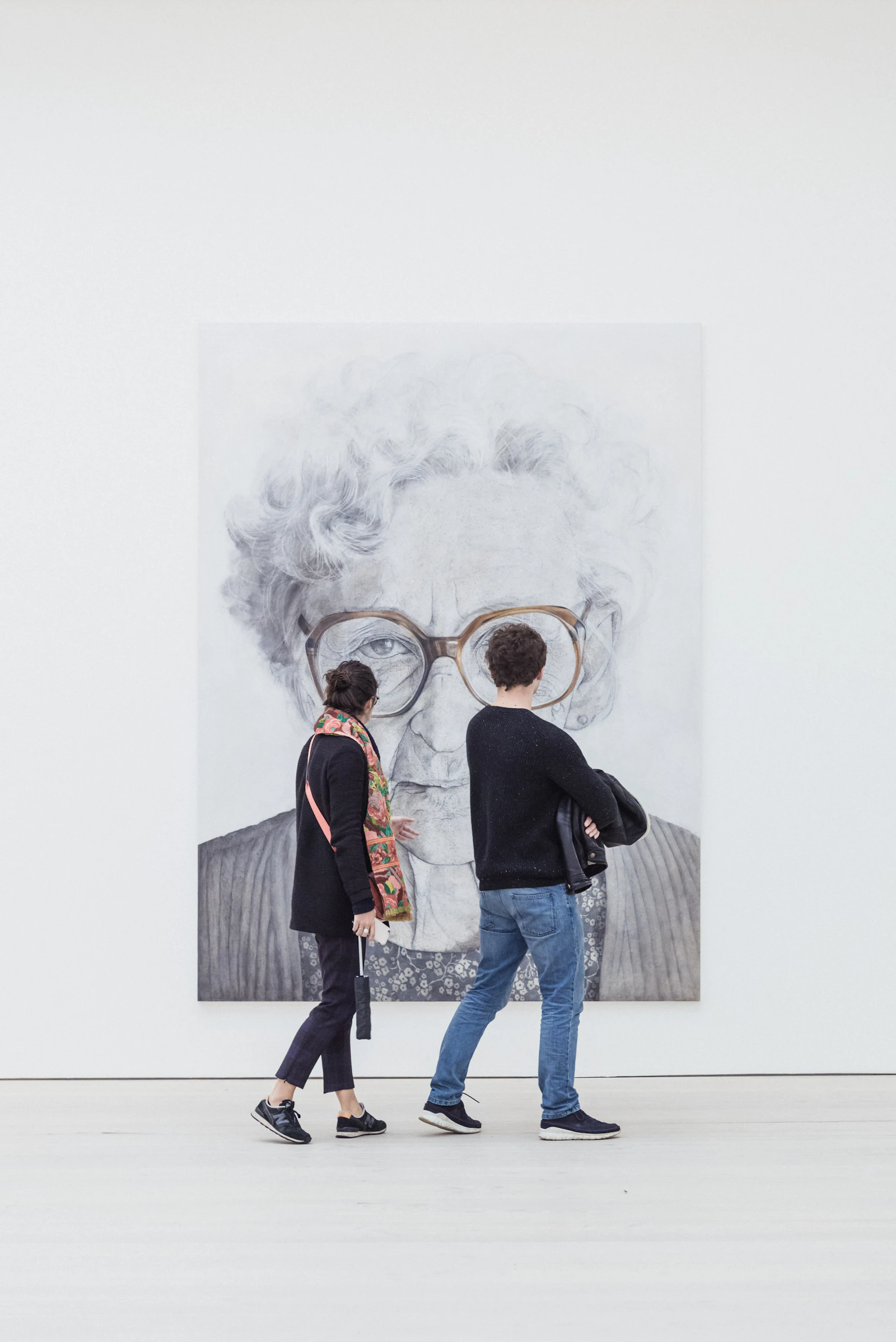 A man and woman looking at a painting together
