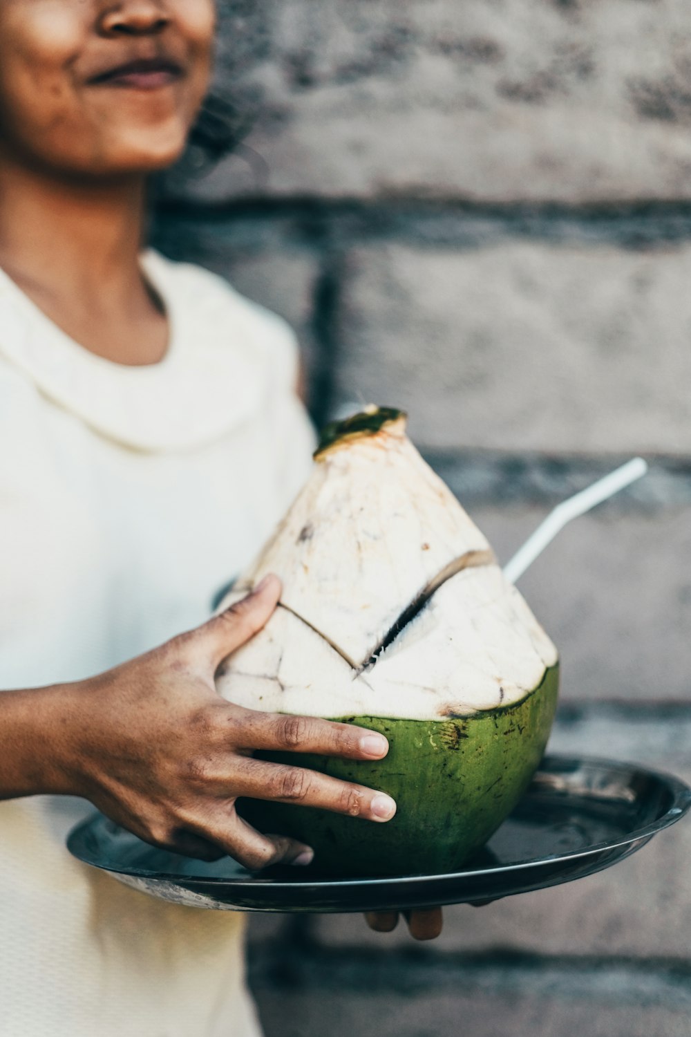 person holding coconut shell