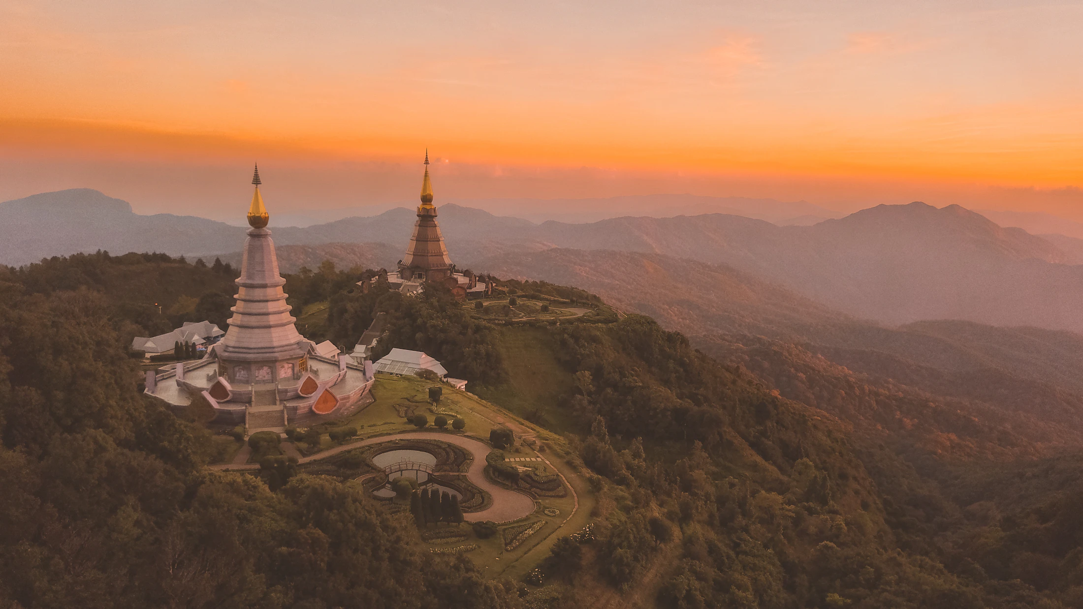 A temple silhouetted against an orange sunrise in northern Thailand