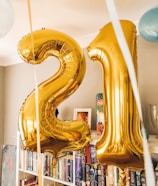 brass-colored 21 foil balloons inside room