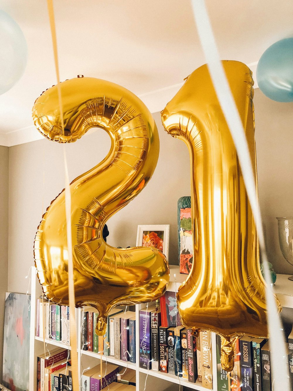 brass-colored 21 foil balloons inside room