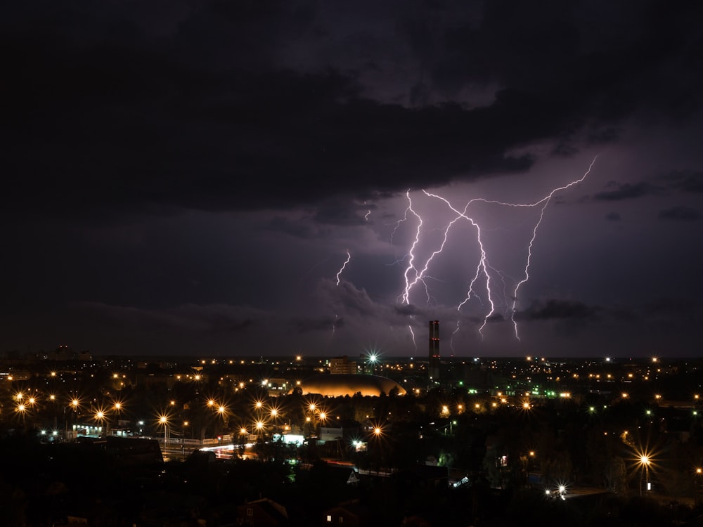lightning over city during nighttime