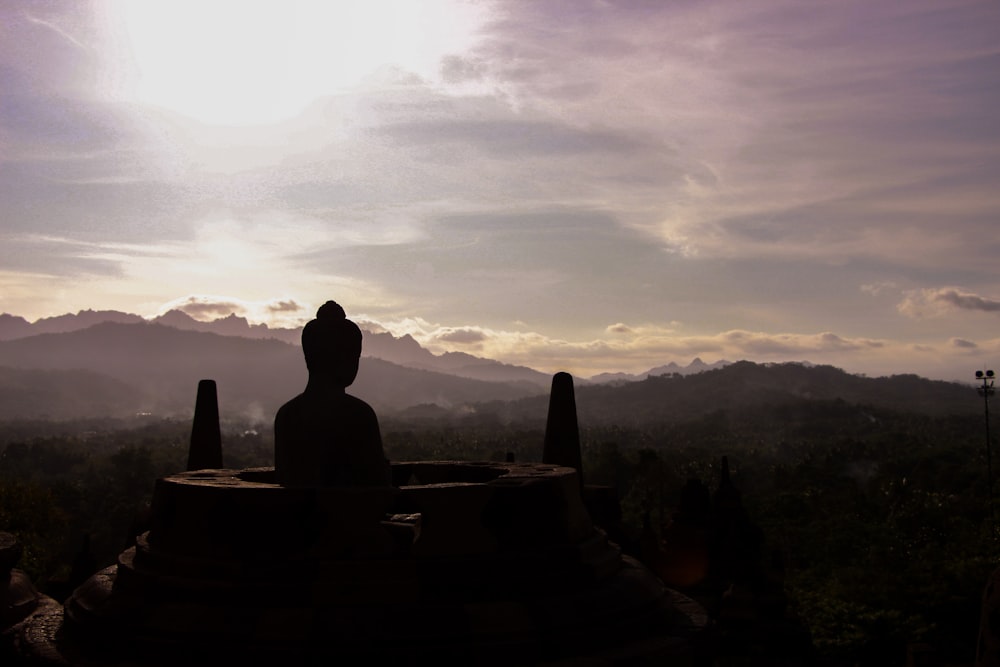 silhouette photography of Buddha monument