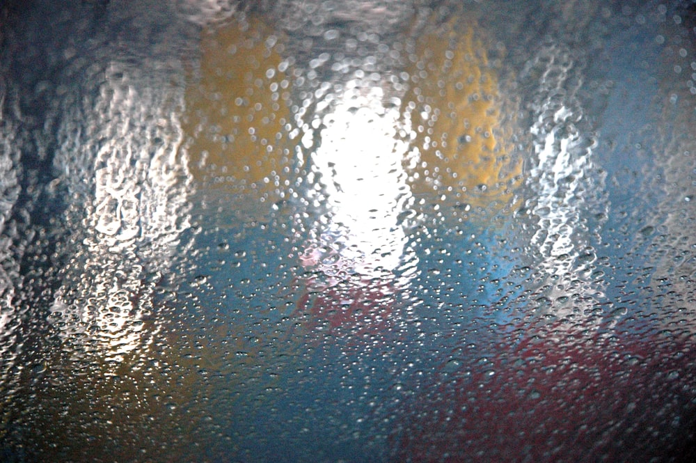 a close up of a rain covered window