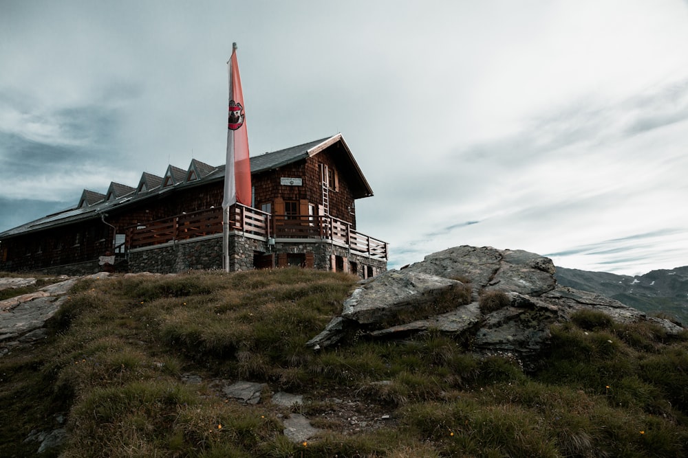 photo of brown house on top of the mountain