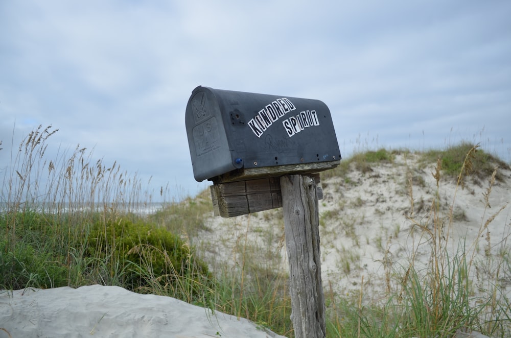 shallow focus photography of mailbox surrounded by grass