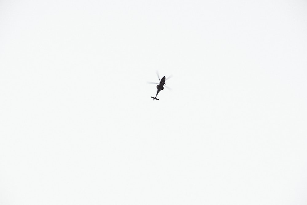 black helicopter on sky during daytime