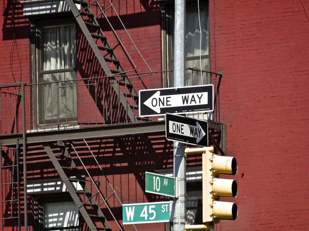 road signage near red painted house