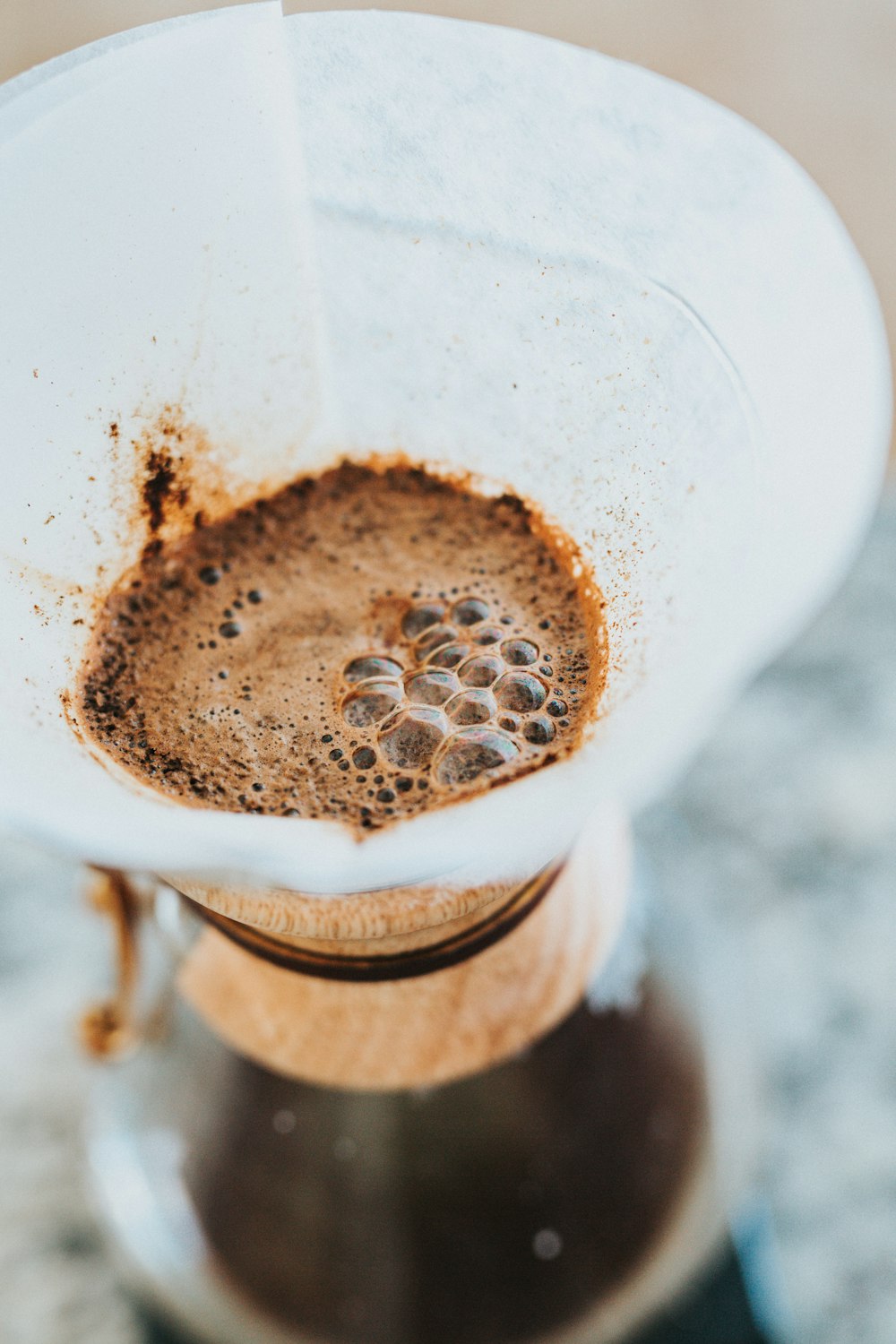 shallow focus photography of funnel with brown liquid