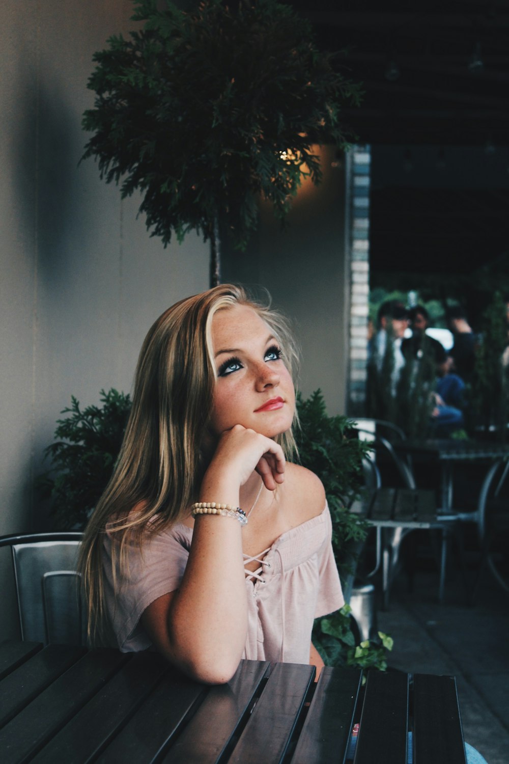 woman sitting on chair looking up