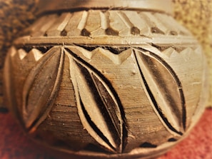 Close-up of a rustic terracotta kullad with intricate hand-carved patterns