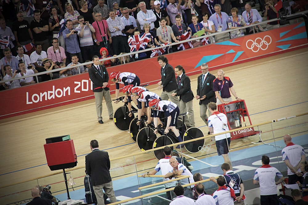 men riding bicycles on starting line at track