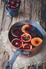 close-up photography of sliced orange fruit on brown cooking pot