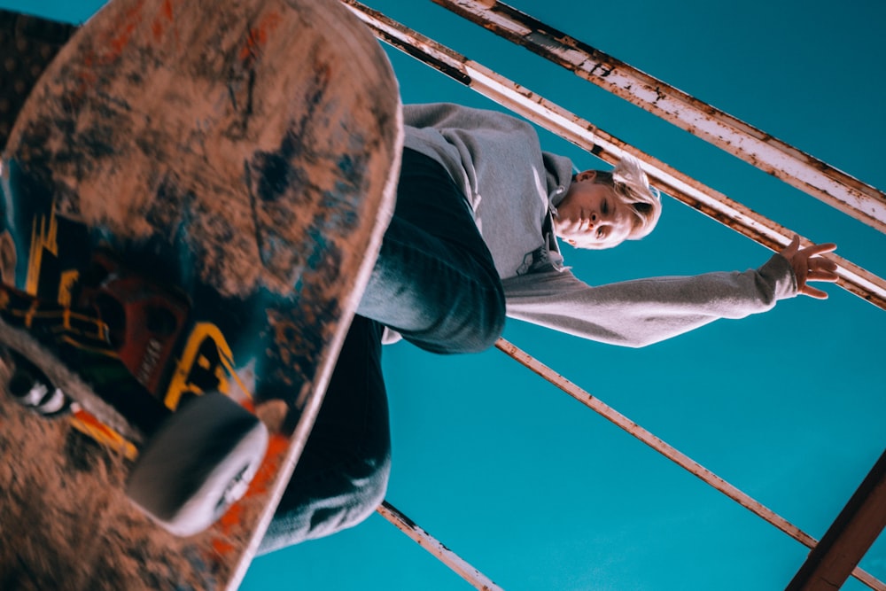 low angle photo of man playing skateboard