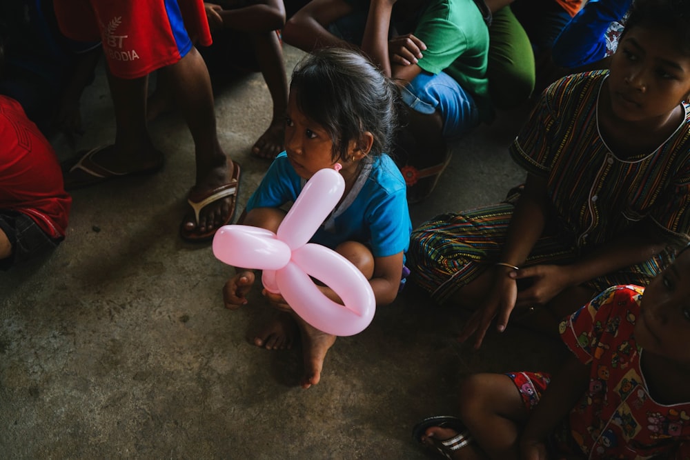 girl holding a pink balloon