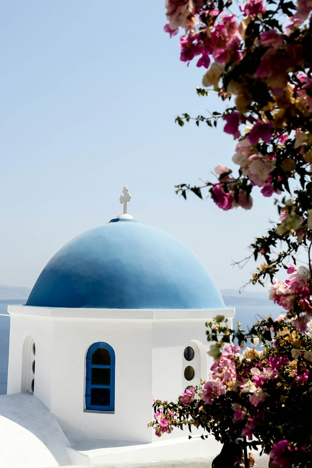 white and blue church near body of water