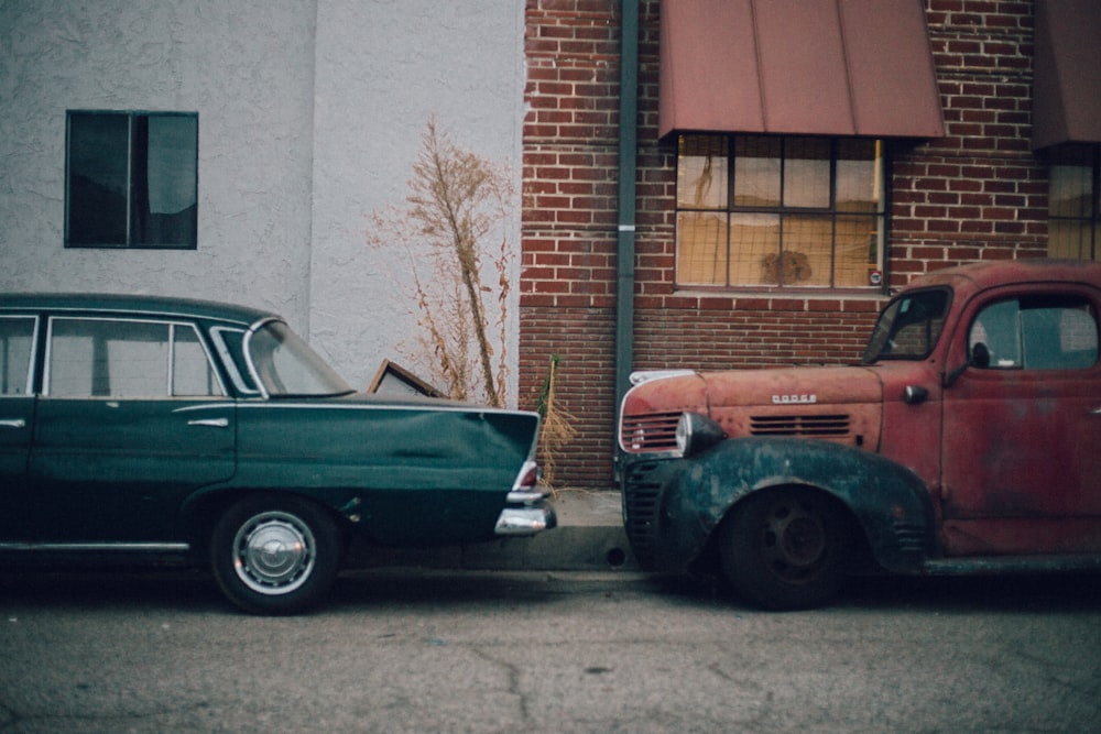 two classic cars parked near building