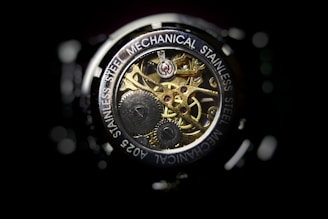 Close-up of a Tissot automatic watch's intricate movement under crystal-clear sapphire glass.