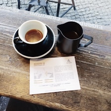 Colorful flyers spread out on a table with a coffee cup nearby
