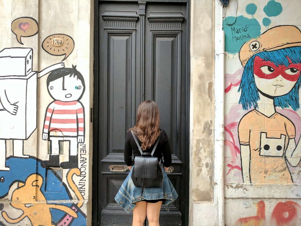 woman wearing black leather knapsack