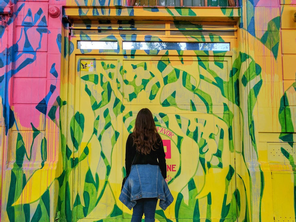 woman in front of multicolored wall