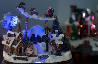 Illustration of Santa Claus and reindeer flying over snowy rooftops.
