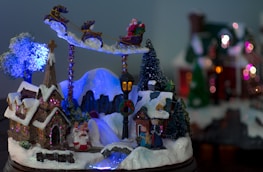 A snowy North Pole village scene at twilight, with cheerful elves working and the radio tower lit up.