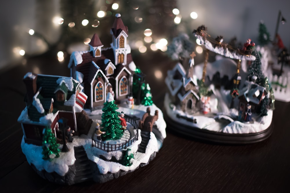 brown and white miniature house on brown wooden plank