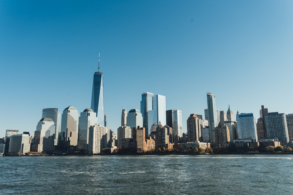 city building near body of water under blue sky