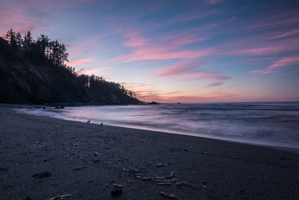 silhouette of mountain in seashores