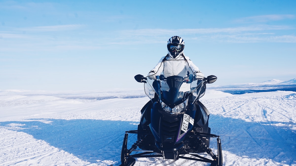 A snowmobiler in a wide snowy clearing