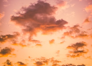 photo of cumulus clouds during golden hour